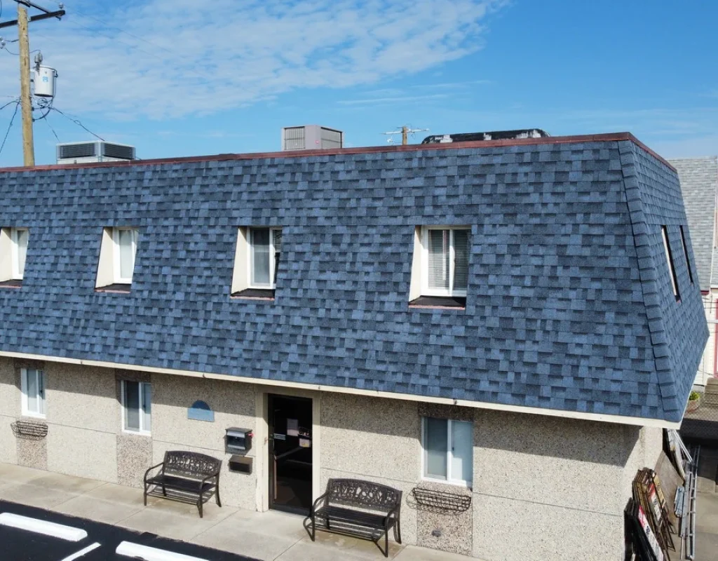 Roofing contractors installing durable shingles on residential properties