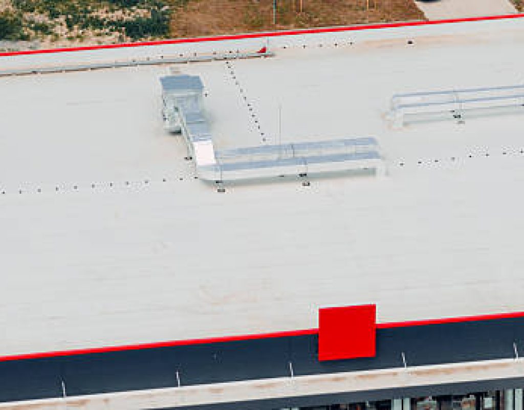 Commercial roofing crew in Atlantic City, NJ checking rooftop drainage and membrane condition near vents