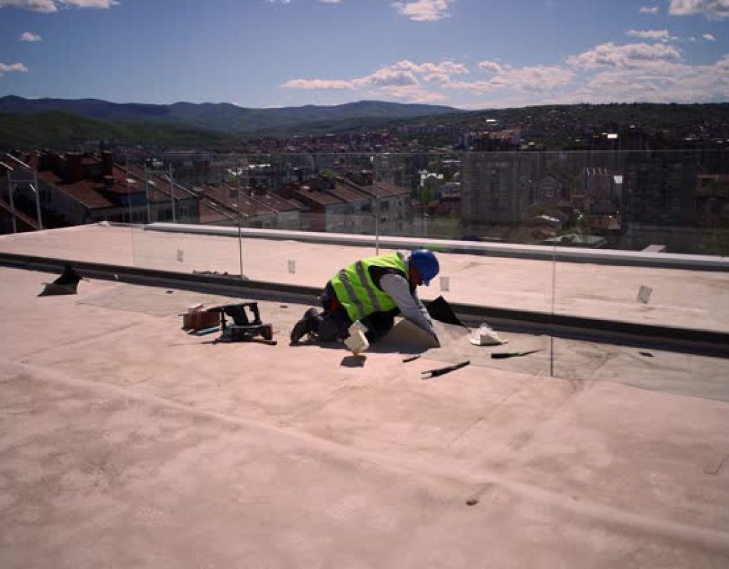 Commercial Roofing in Pleasantville, NJ as technicians examine a flat roof near rooftop equipment