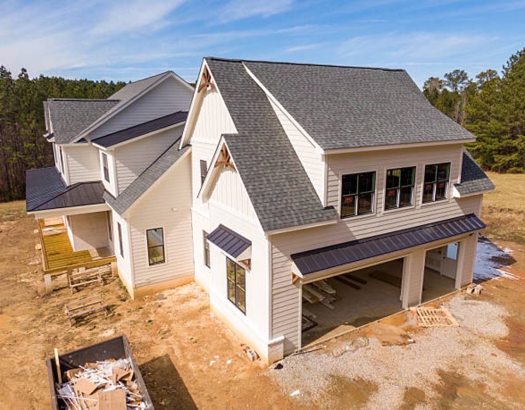Experienced roofing team repairing damaged residential roofing systems